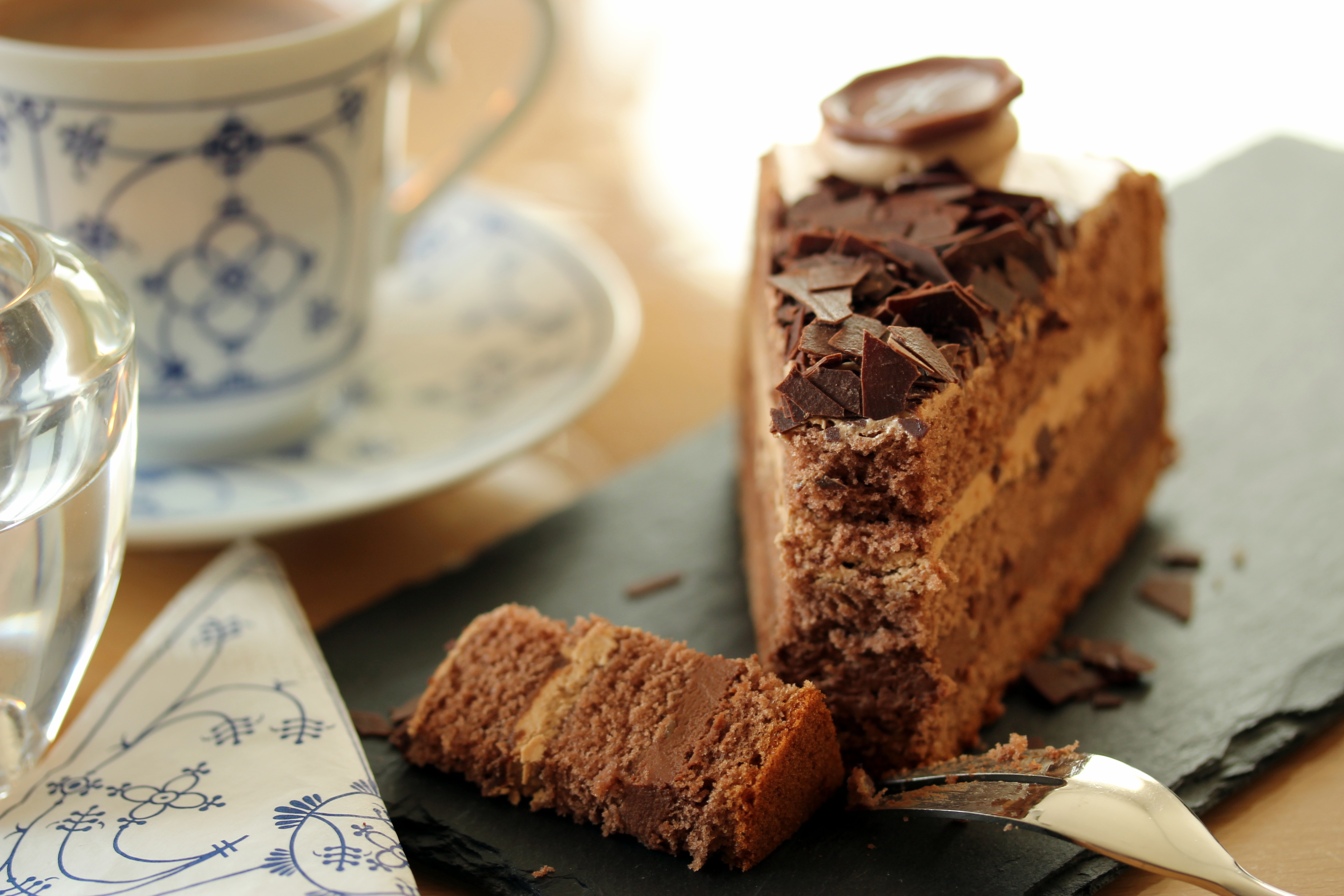Slice of chocolate cake with tea